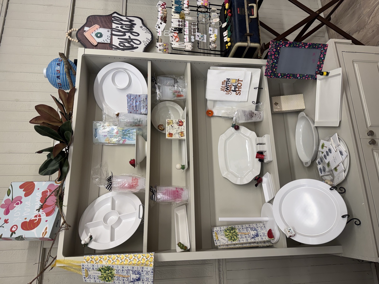 The hutch of white serveware and gifts