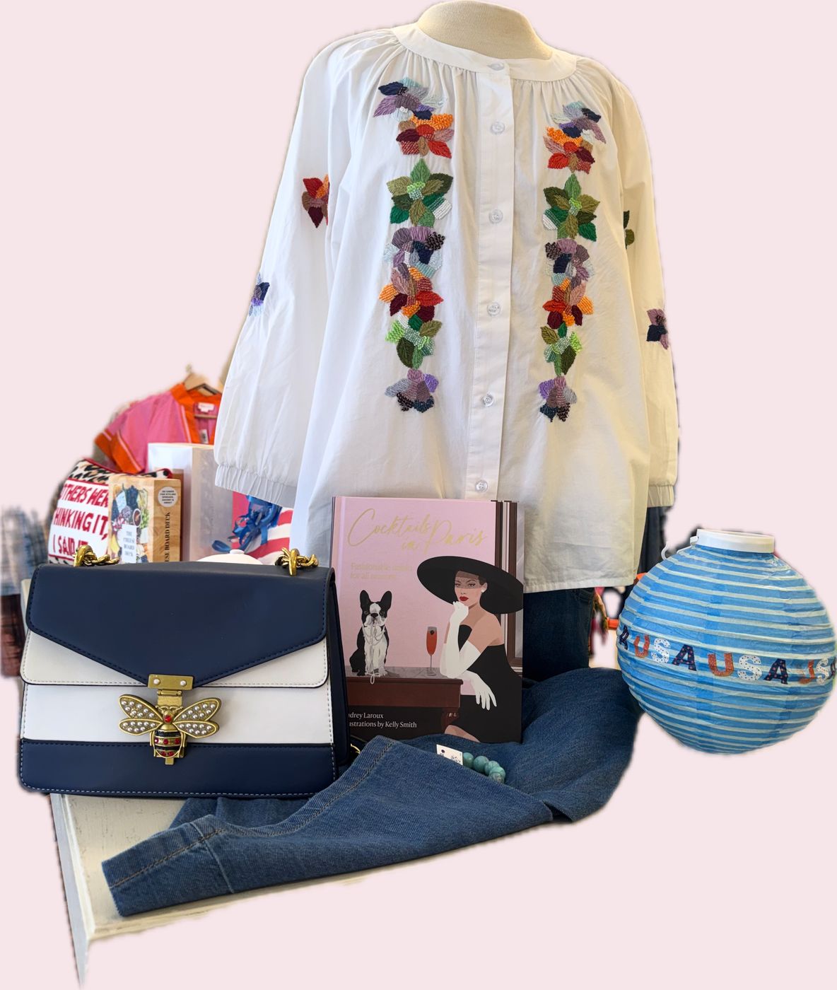 Embroidered blouse, bee-clasp bag, and a paper lantern — a shop vignette